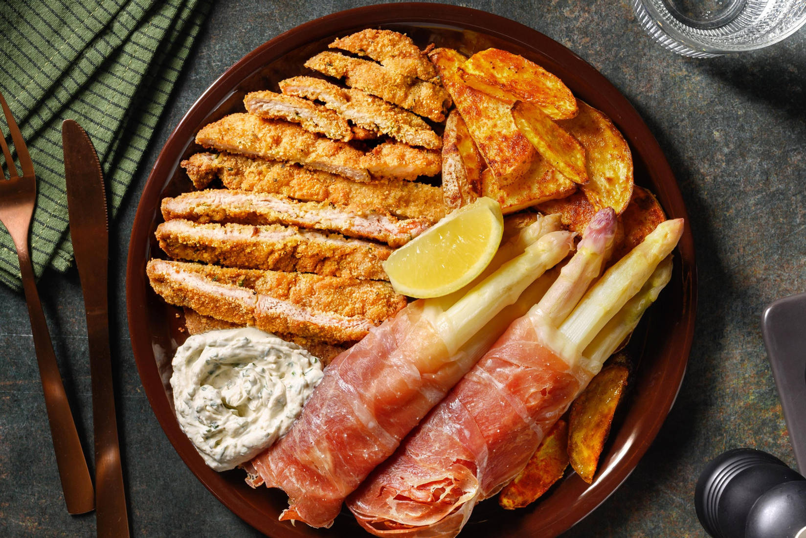 Kräuterschnitzel mit Spargel in Prosciutto