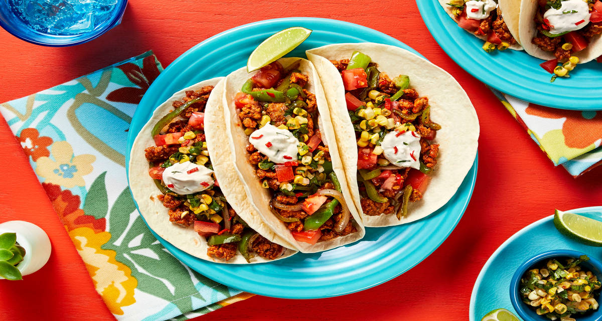 Pork and Charred Corn Chimichurri Tacos with Lime Crema and Tomato
