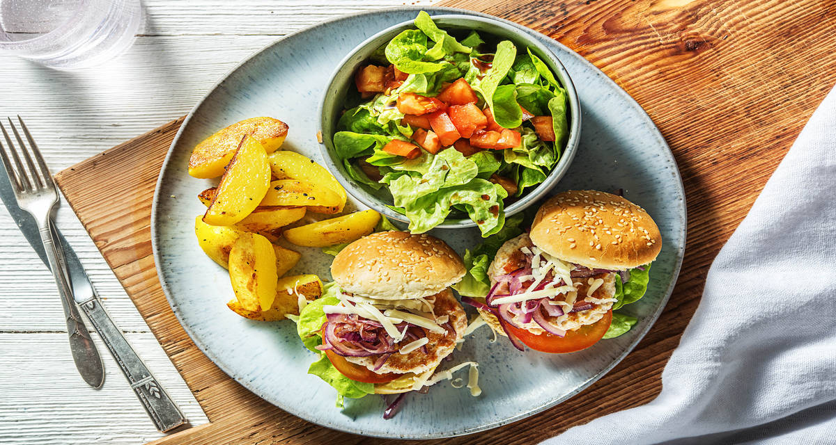 Cheeseburger au poulet et aux oignons rouges caramélisés Avec des pommes de terre rissolées et une salade