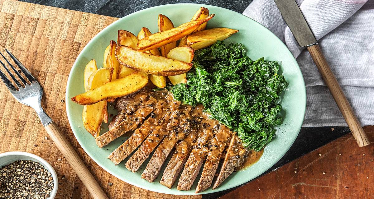 Crushed Peppercorn Steak with Creamed Kale and Potato Wedges