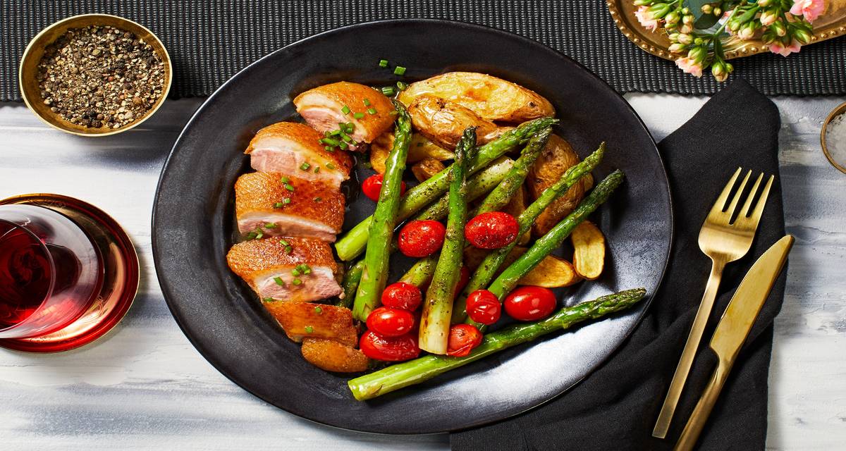 Pan-Seared Duck Breasts with Duck-Fried Potatoes, Asparagus, and Grape Tomatoes