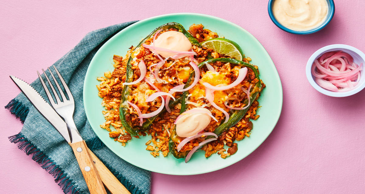 Tex-Mex Turkey Stuffed Poblanos with Smoky Red Pepper Crema & Pickled Red Onion