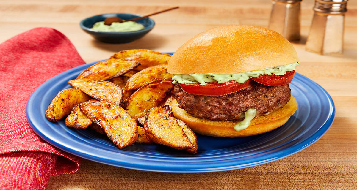 Mozz-Stuffed Caprese Burgers with Griddled Tomato, Creamy Pesto & Potato Wedges