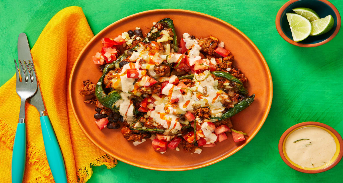 Pork Chili 'n' Cheese Stuffed Poblanos with Black Beans, Fresh Salsa & Smoky Red Pepper Lime Crema image