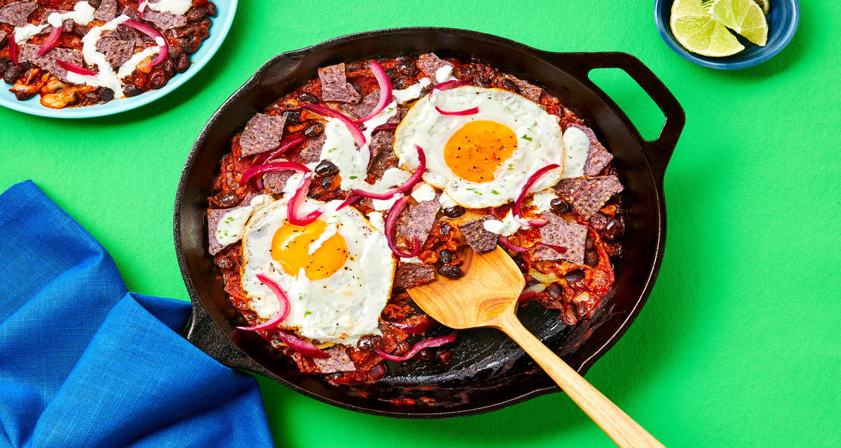 Blue Corn Tortilla Skillet with Eggs, Black Beans, Lime Crema, Pickled Onion & Pepper Jack