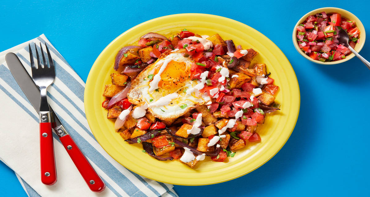 Steak & Eggs over Nacho Potato Hash with Pico de Gallo & Smoky Red Pepper Crema