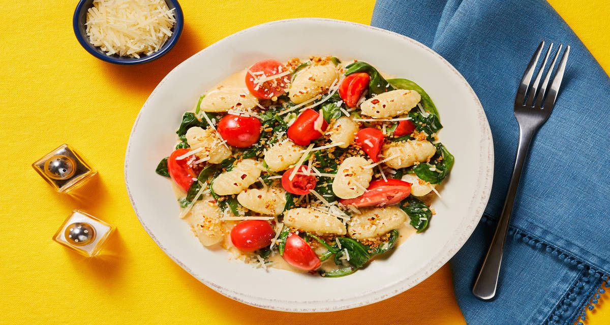 Gnocchi with Spinach & Tomatoes topped with Garlic Butter Breadcrumbs & Parmesan