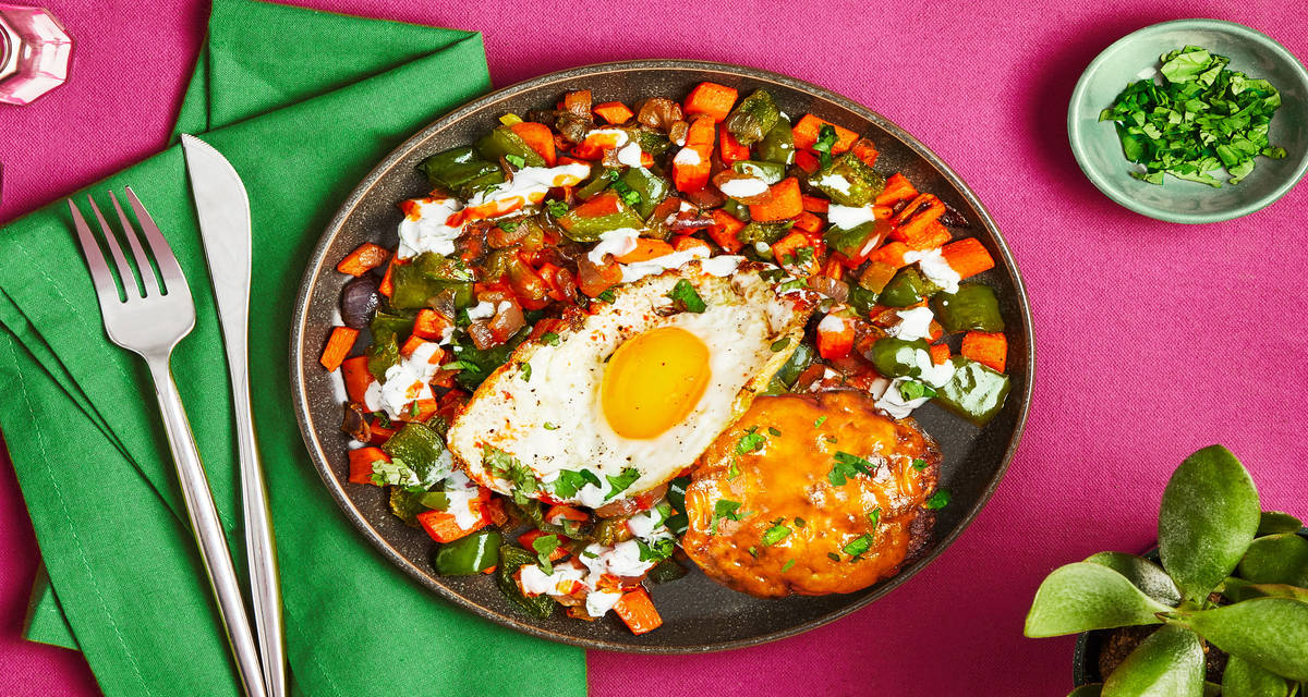 Sunny Southwest Beef Patties veggie hash, fried eggs, cheddar cheese, crema, Cholula
