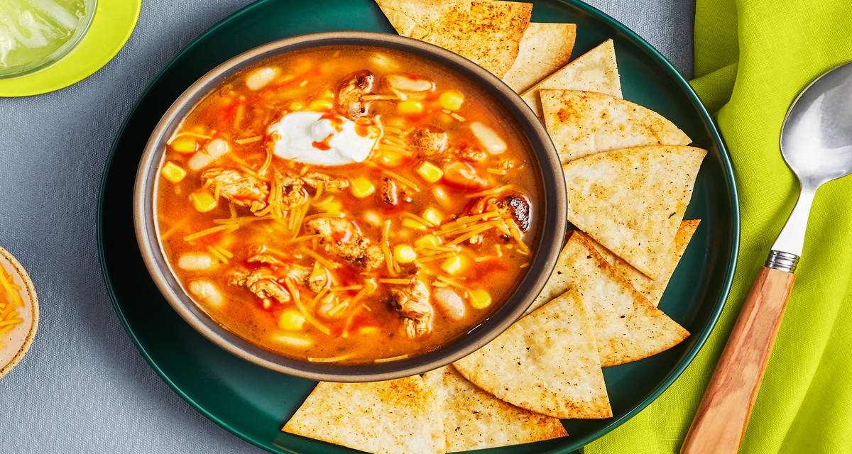 Chicken & White Bean Soup cheddar cheese, sour cream, Cholula sauce, tortilla chips