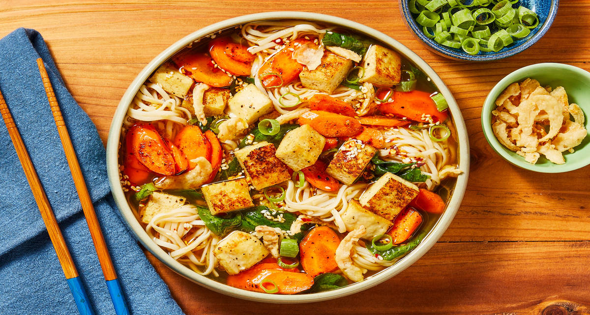 Vegan Tofu Ramen in a Ginger-Soy Broth with Carrots, Spinach, Sesame-Chili Oil & Crispy Onions