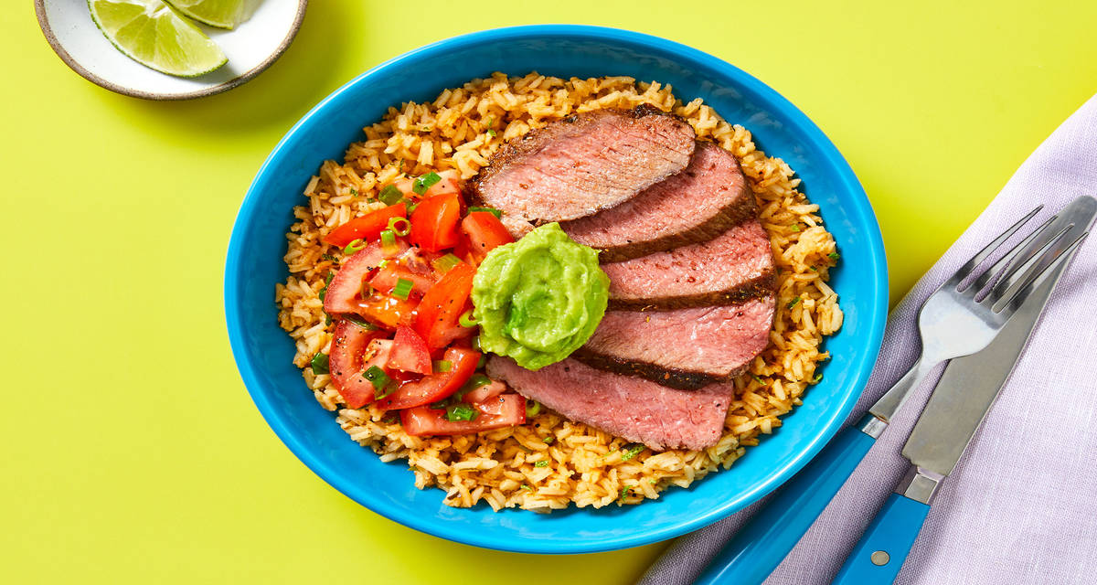 Zesty Mexican-Spiced Steak Bowls with Garlic Rice, Marinated Tomato & Guacamole