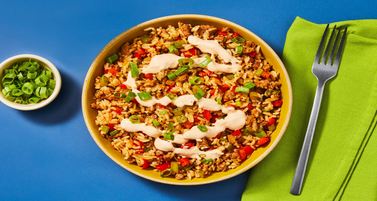 Cajun-Style Pork Sausage Dirty Rice with Smoky Red Pepper Crema