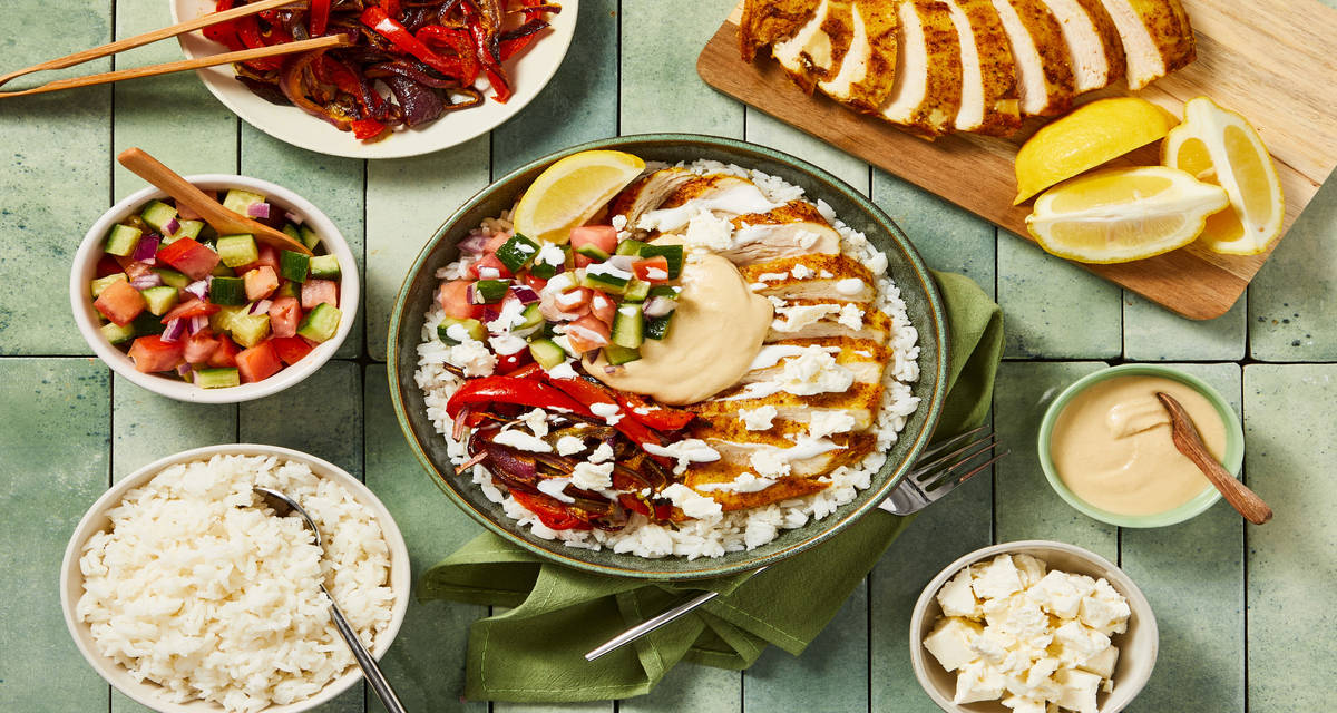 Loaded Shawarma-Style Chicken & Rice Bar with Roasted Bell Peppers, Hummus, Tomato-Cuke Salad & Feta