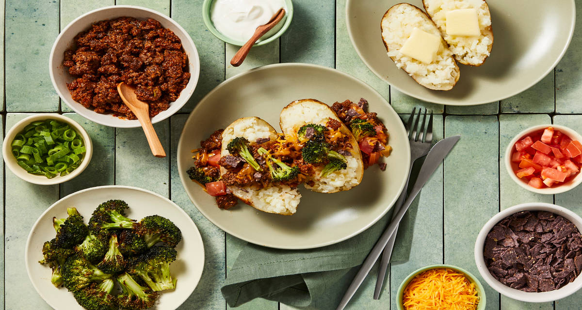 Loaded Beef Chili Baked Potato Bar with Tortilla Chips, Broccoli, Cheddar, Tomato, Sour Cream & Scallions