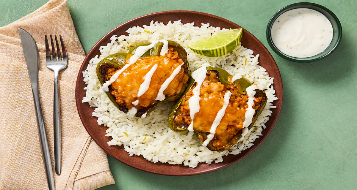 Spicy Cheesy Cauli-Stuffed Bell Peppers with Tex-Mex Spices, Zesty Rice & Lime Crema