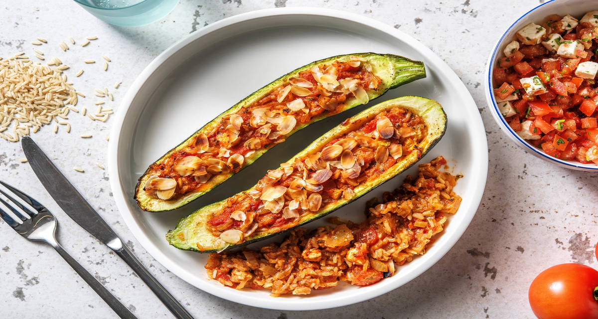 Courgettes farcies à la turque & amandes effilées avec une salade de tomates, feta et herbes fraîches