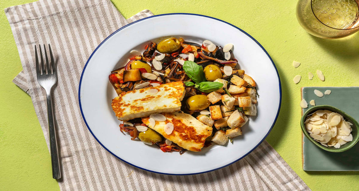 Formaggio fondente e caponata di melanzane con olive e crostini integrali al basilico
