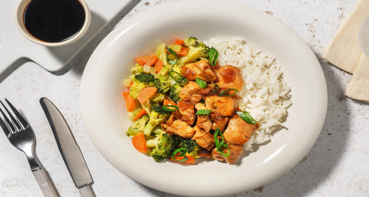 Kippendij in zoete Aziatische saus met rijst, lente-ui en groenten
