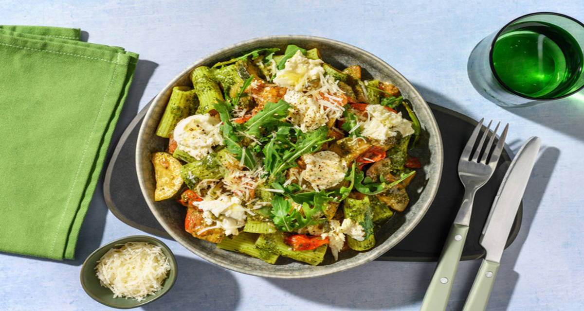 Rigatoni al pesto de rúcula con mozzarella italiana con calabacín y tomates cherry salteados