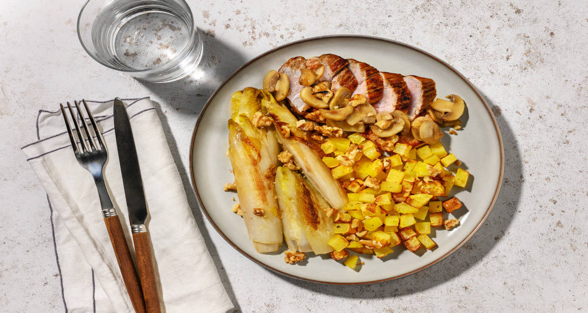 Porc sauce forestière, endives braisées & noix avec des pommes de terre au four
