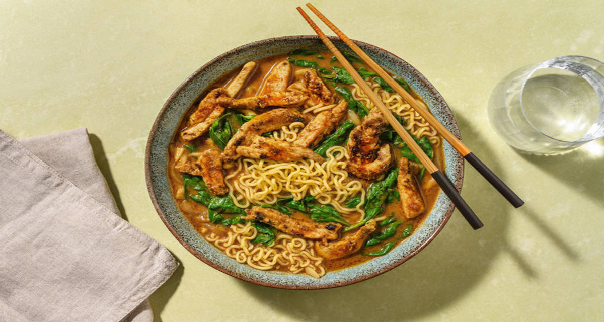 Sopa asiática roja de miso con lomo adobado con fideos udon y espinacas