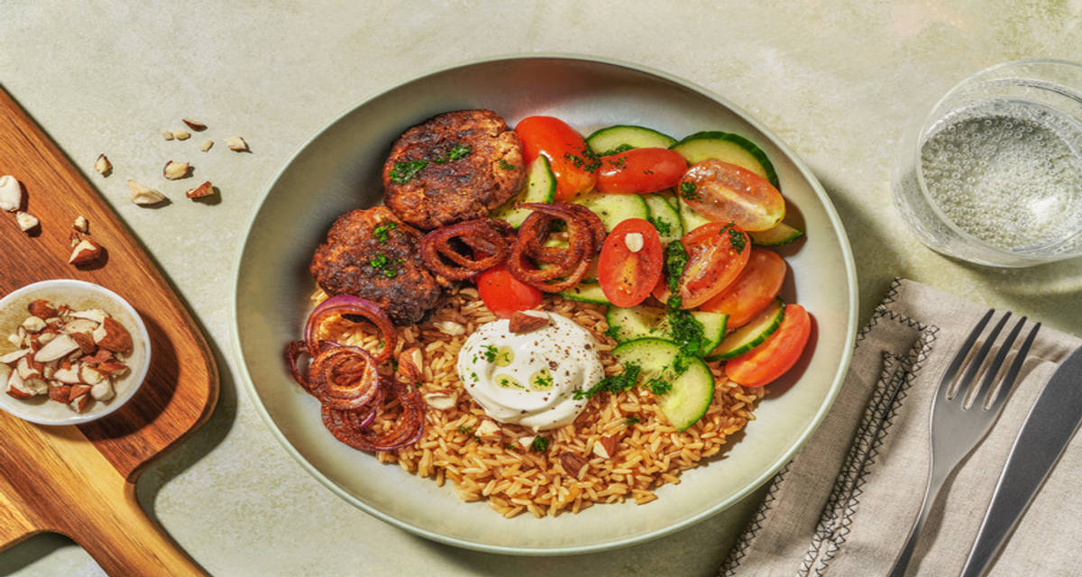 Kipköfte met labneh en kruidenolie met bruine rijst, sumak-uien en salade