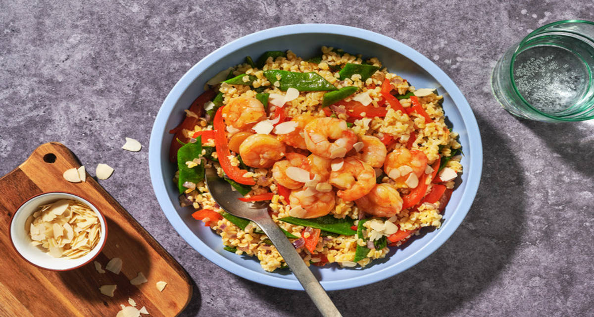 Crevettes en sauce à l'orange & amandes effilées boulgour, poivron et haricots plats