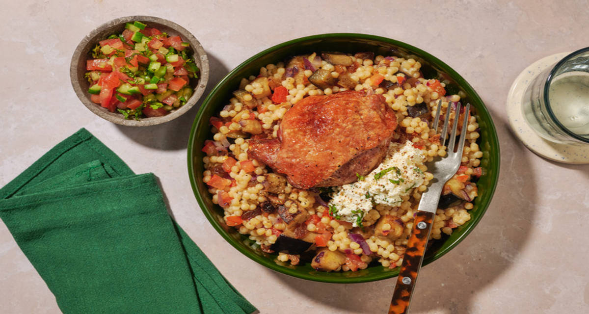 Confit de cuisse de canard, aubergine & labné à la menthe couscous perlé, ras el hanout et salade