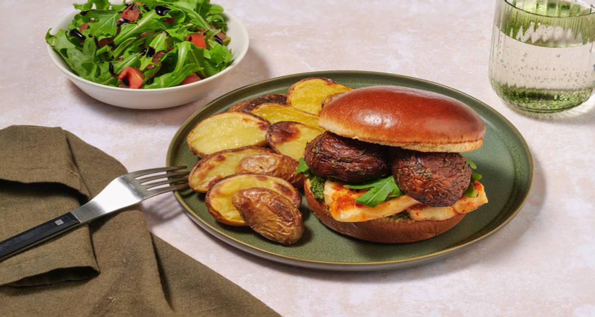 Glazed Double Halloumi and Portobello Mushroom Burger with pesto, baby potatoes and balsamic dressed salad