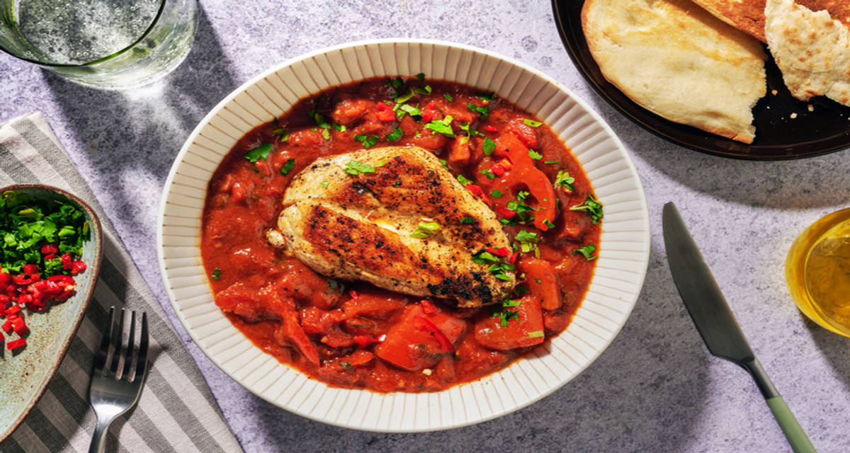 Harissa Chicken and Bell Pepper Stew with warm and fluffy naan