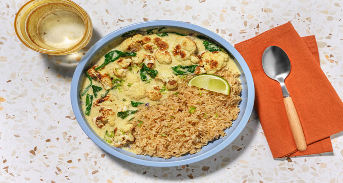 Roasted Cauliflower in Thai Green Curry Sauce over rice with spinach and lemongrass