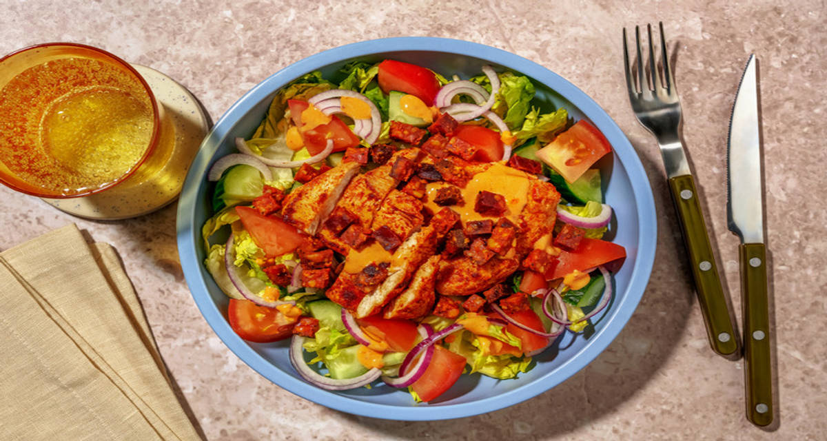 Nduja Hollandaise Chicken and Chorizo Salad with onion, tomato and cucumber