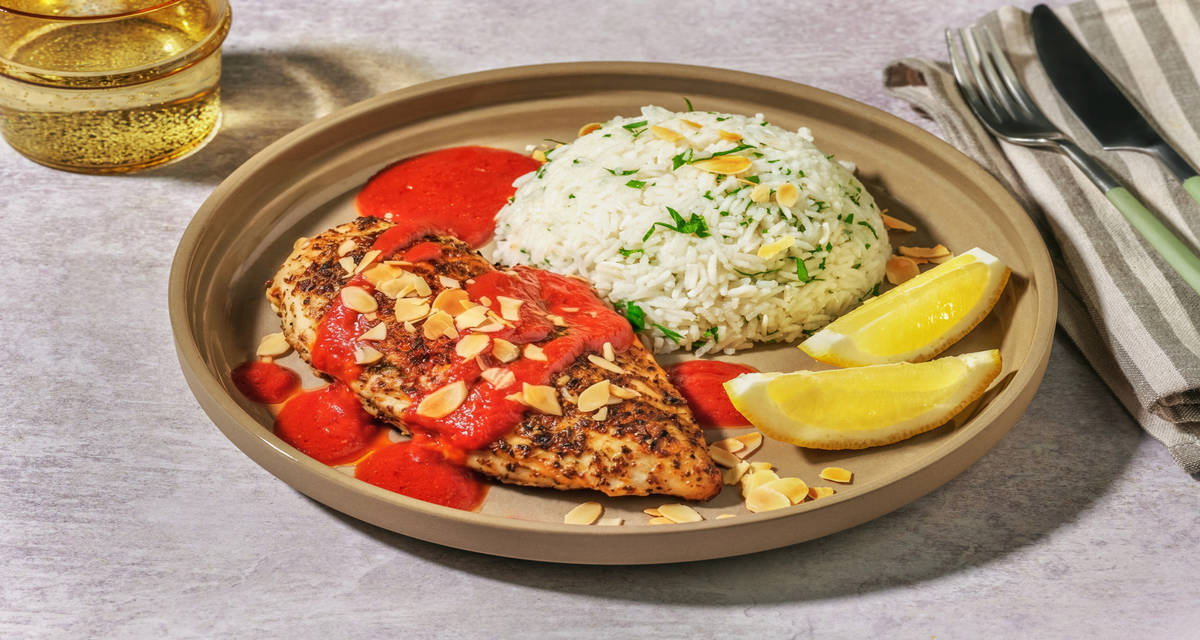 Lebanese-inspired Chicken Breast and Rice with flaked almonds and lemon wedges