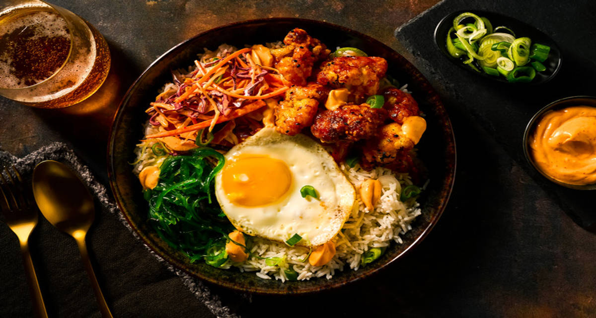 Gefrituurde bloemkool op z'n Koreaans in pikante gochujangsaus met rijst, zeewiersalade, kimchi-koolsla en gebakken ei