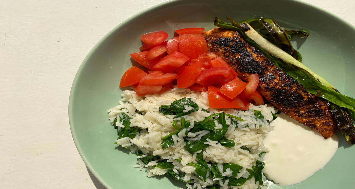 Blackened cajun salmon with garlic spinach rice and lime yoghurt