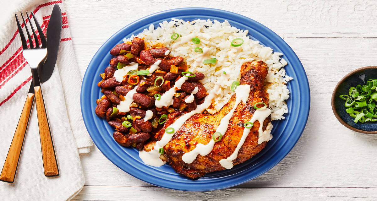 Bayou Blackened Chicken Legs with Smoky Red Beans, Buttery Rice & Hot Sauce Crema