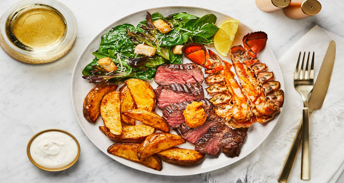Chesapeake Steak & Lobster Tail with Oven Fries, Creamy Lemon Garlic Sauce & a Mixed Greens Caesar