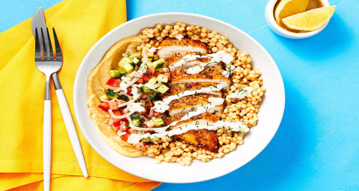Chicken Gyro Couscous Bowls with Hummus, Tomato-Cucumber Salad & Feta Sauce-image