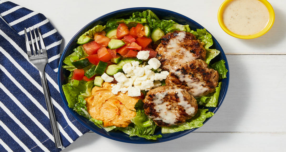 Greek Salad With Spiced Pork Patties plus Red Pepper Hummus, Feta & Creamy Vinaigrette