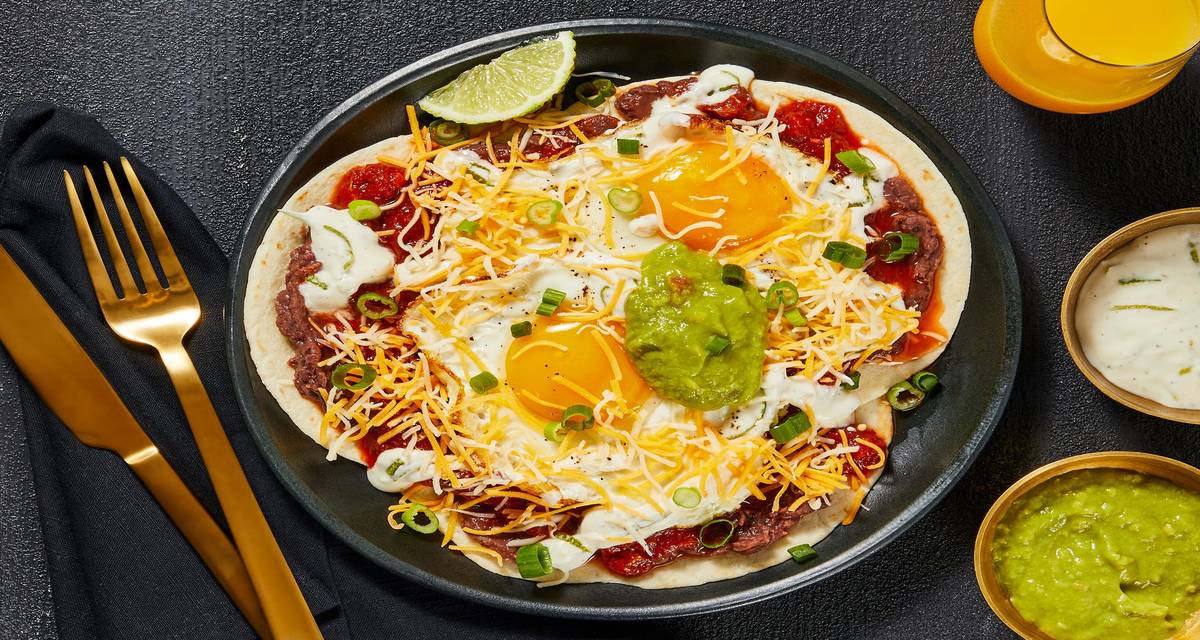 Huevos Rancheros with Fried Eggs, Guacamole, Cheese & Lime Crema