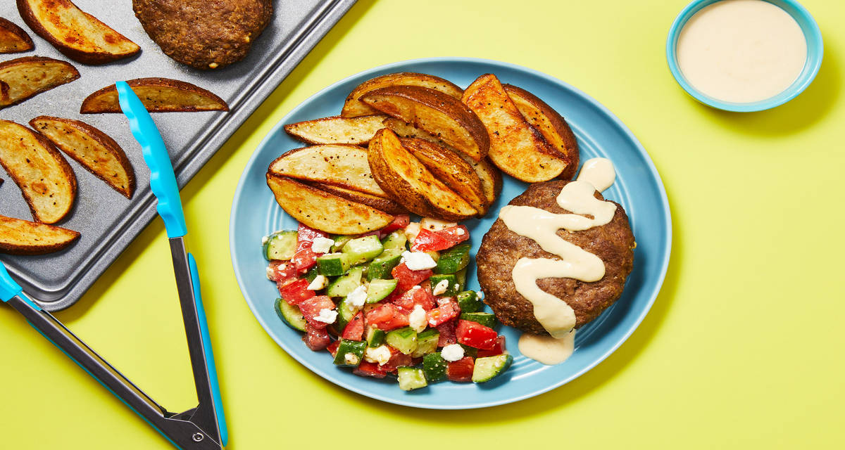 Sheet Pan Beef & Feta Meatloaves with Tomato Salad, Hummus Sauce & Potato Wedges