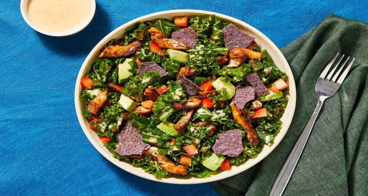 Spicy Kale Caesar with Chicken tossed with Avocado, Tomato & Tortilla Chips