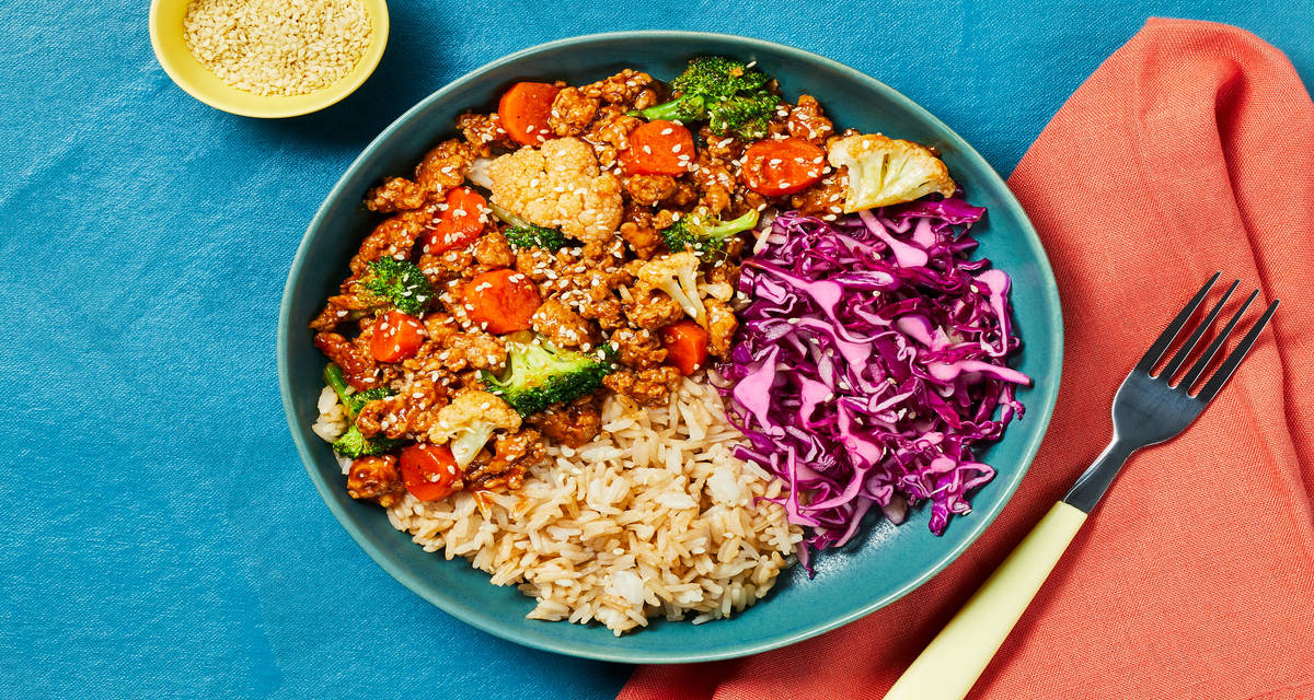 Spicy-Sweet Turkey Stir-Fry Rice Bowls with Gochujang Sauce, Pickled Cabbage & Sesame Seeds