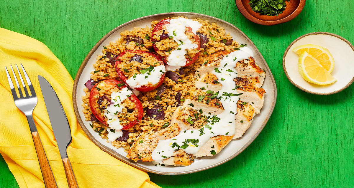 Za’atar-Spiced Chicken with Bulgur-Stuffed Roasted Tomatoes & Lemon Garlic Yogurt Sauce