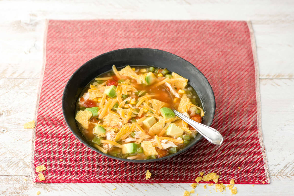 Alexis’ Tortilla Soup with Sweet Corn, Avocado, and Cheddar