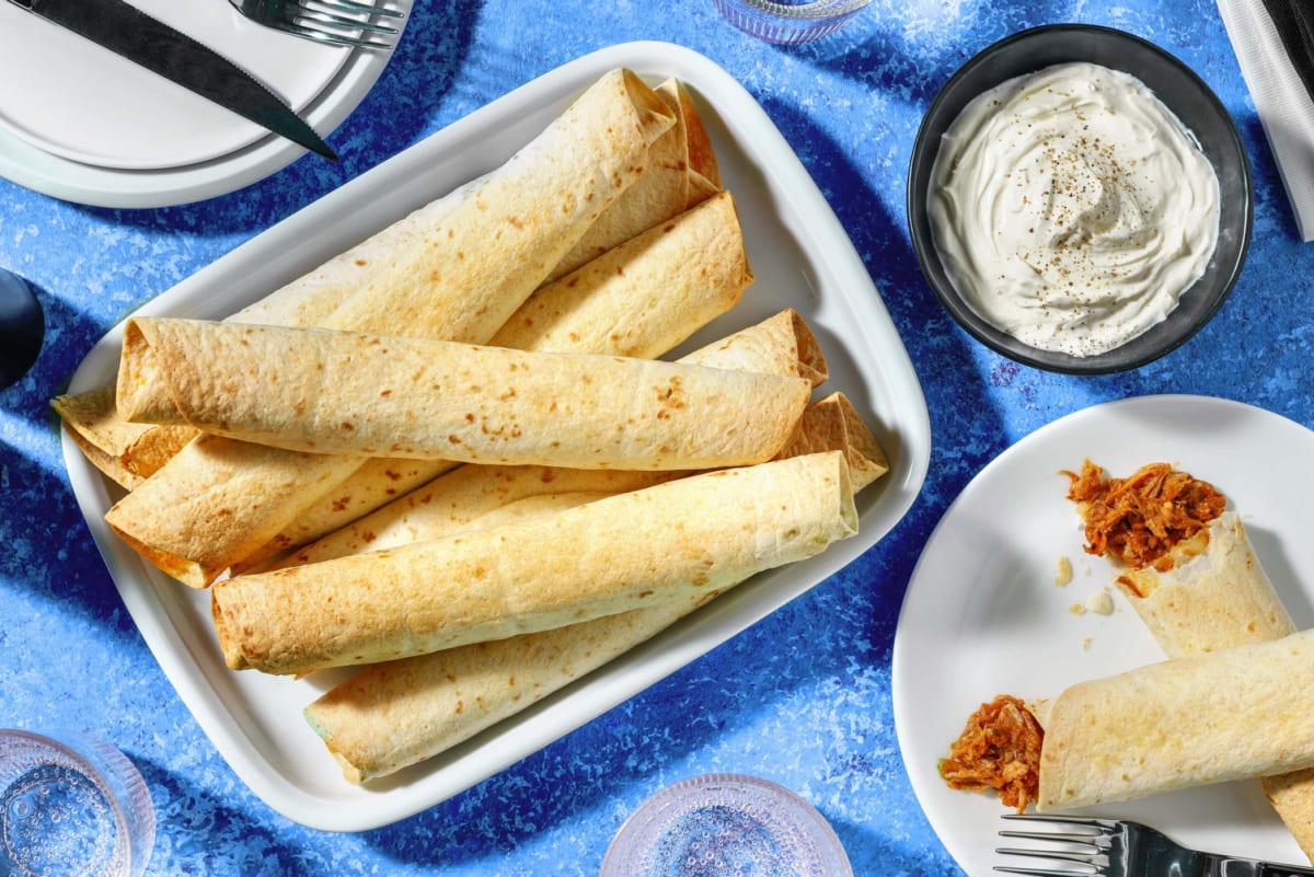 Pulled pork taquitos with enchilada sauce