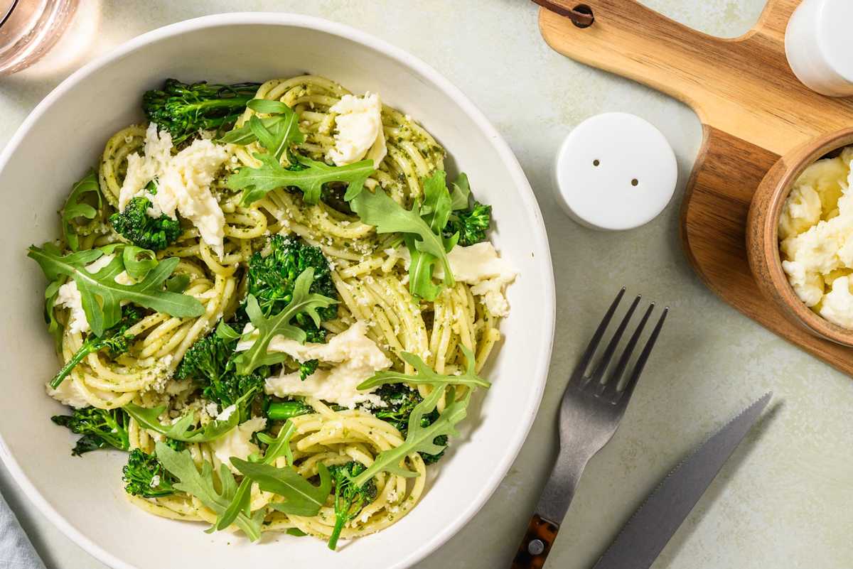 Spaghetti with homemade pesto sauce and greek cheese
