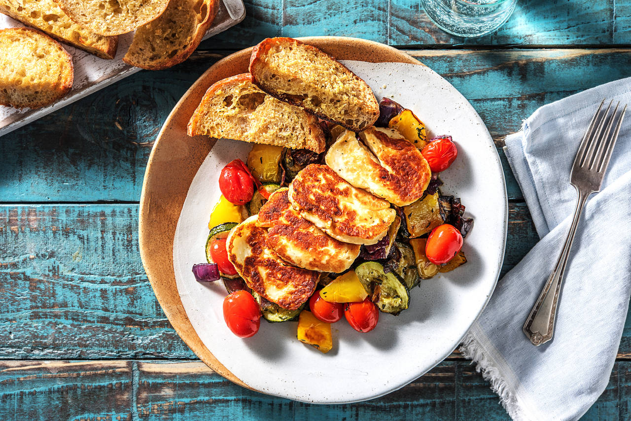 Queso estilo chipriota a la plancha con ratatouille aderezado con vinagreta y pan de ajo