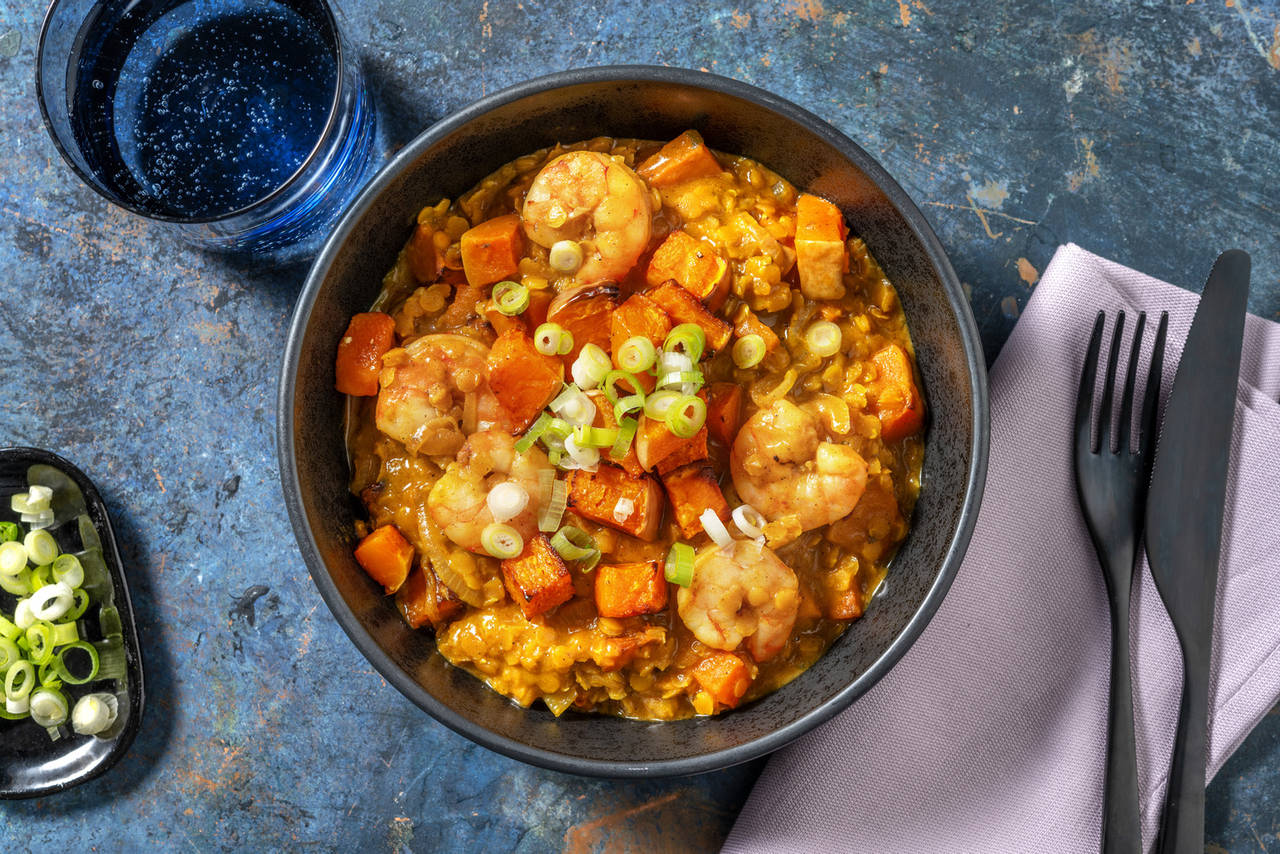 Dal de lentejas con langostinos con boniato asado y ajo tierno