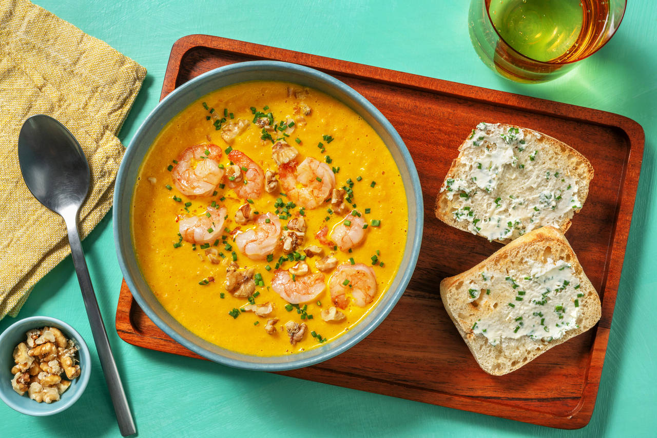 Crema casera de zanahoria, gambas y nueces acompañada de pan al cebollino